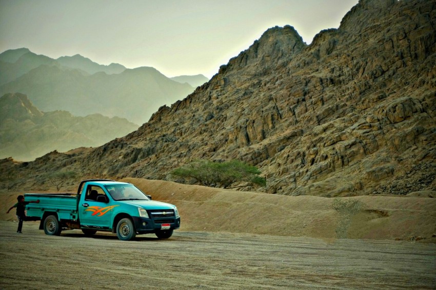 a truck parked on a dirt road