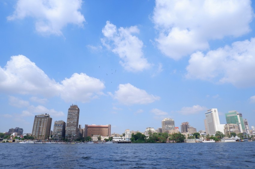 a body of water with a city in the background