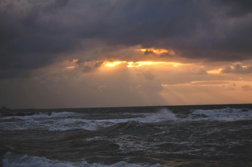 a large body of water under a cloudy sky