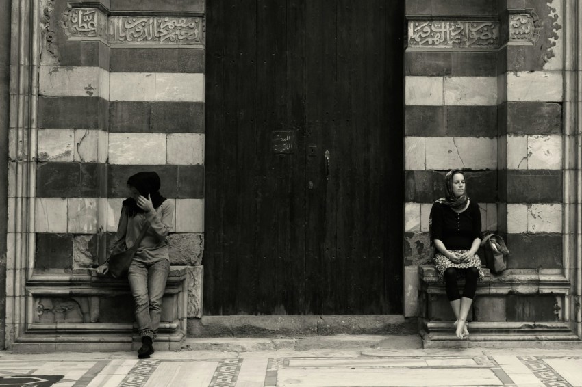 man in black jacket sitting on the floor