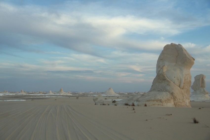 a large rock in the middle of a desert