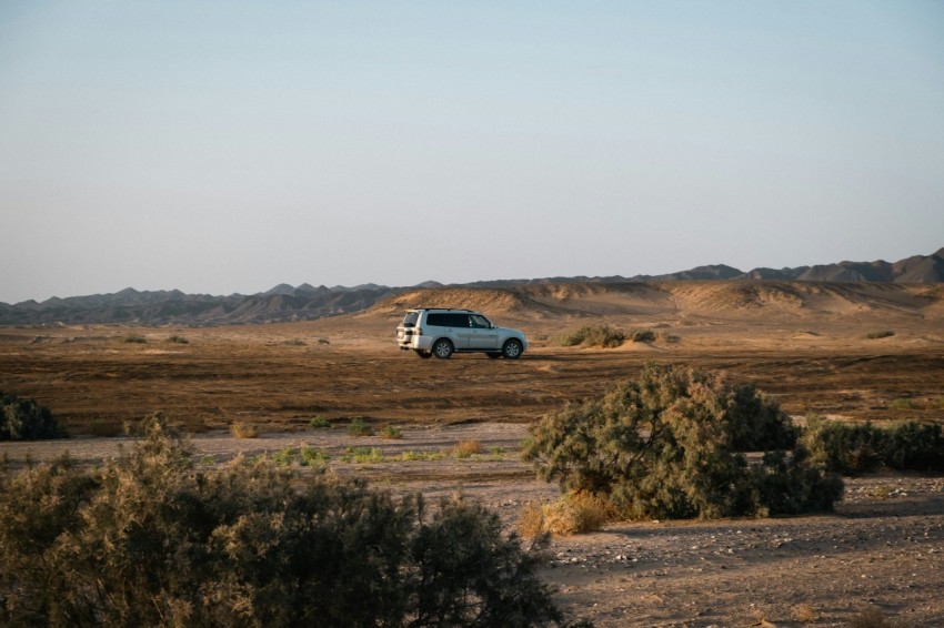 a van is parked in the middle of the desert