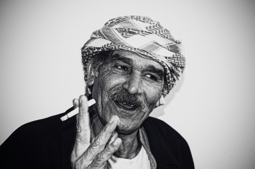 man in black shirt with white and black bandana