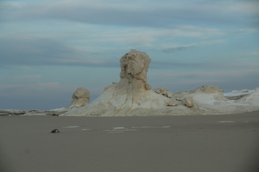 a large rock formation in the middle of a desert