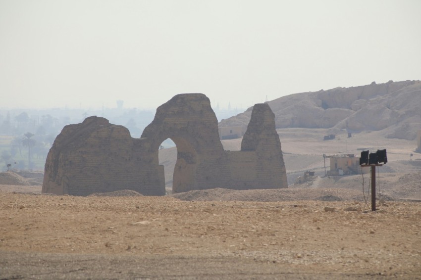 a stone arch in the middle of a desert