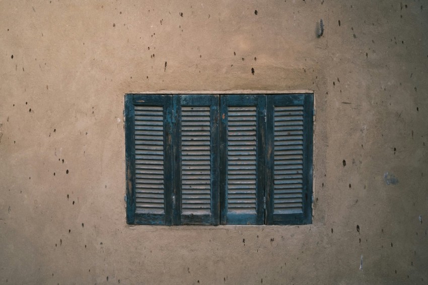 a window with shutters on a building