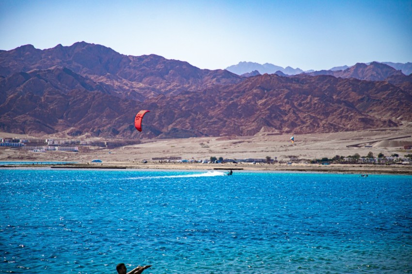 a person flying a kite over a body of water z7