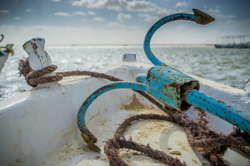 a rusted out boat in the middle of the ocean