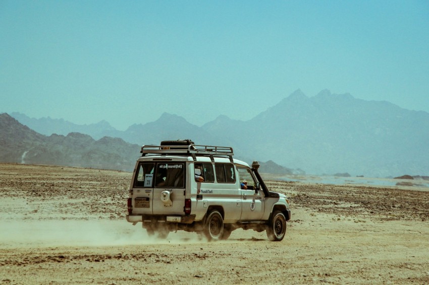 brown suv on brown dirt road during daytime