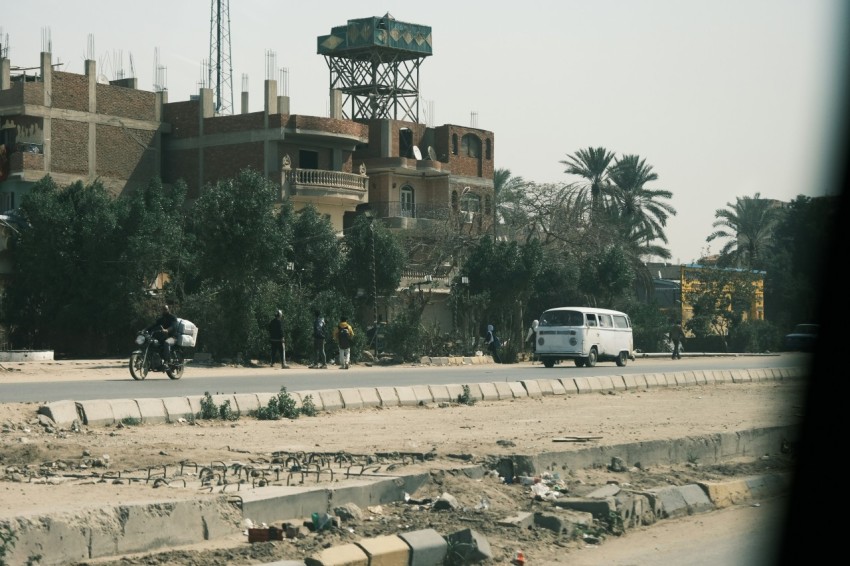 a road with a building and trees