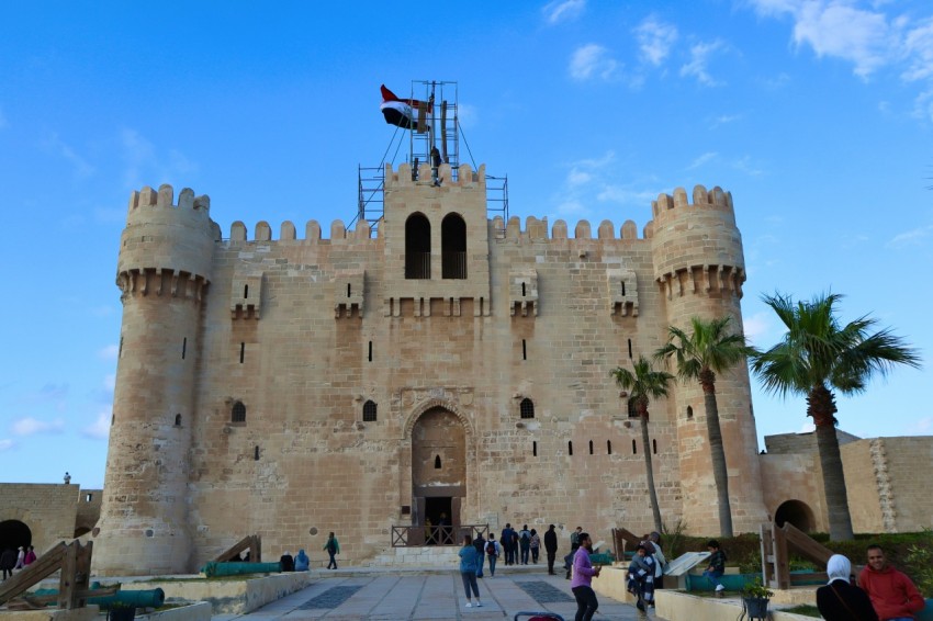 a group of people standing in front of a castle