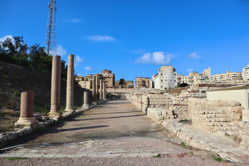 a street lined with stone pillars and buildings