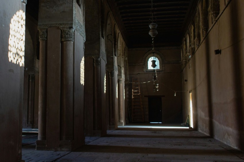 a long hallway with columns and a window W3F