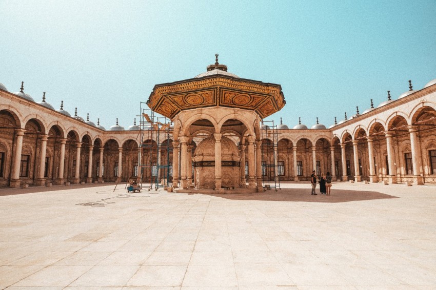 a large courtyard with arches and arches around it