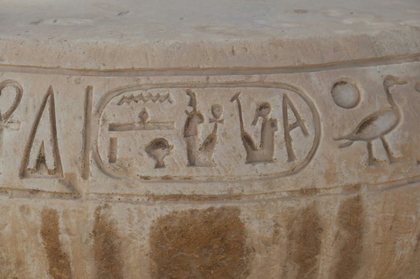 a close up of a stone object with writing on it