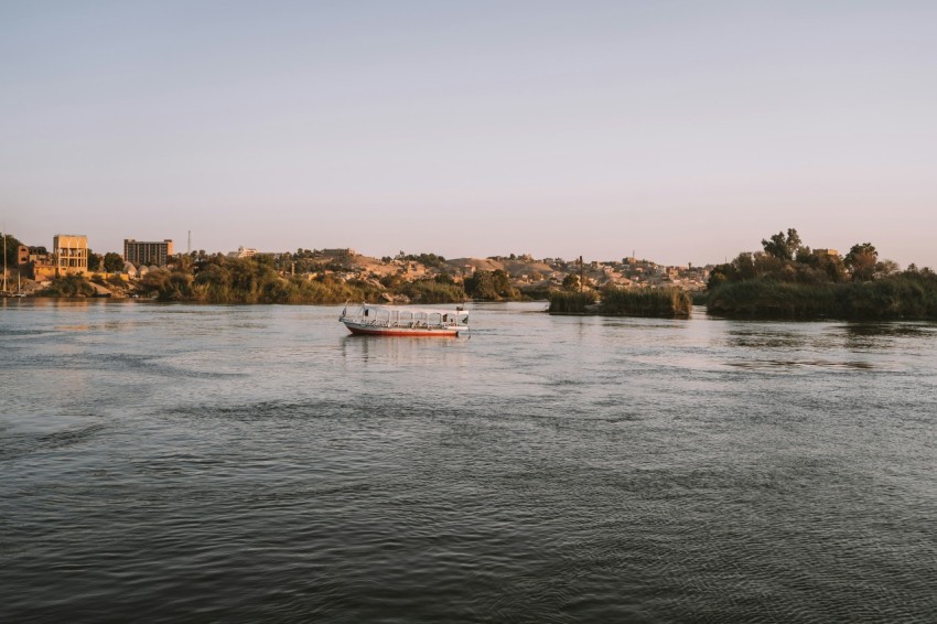 a boat on a river with a city in the background