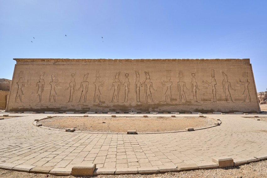 a large stone wall with statues on it