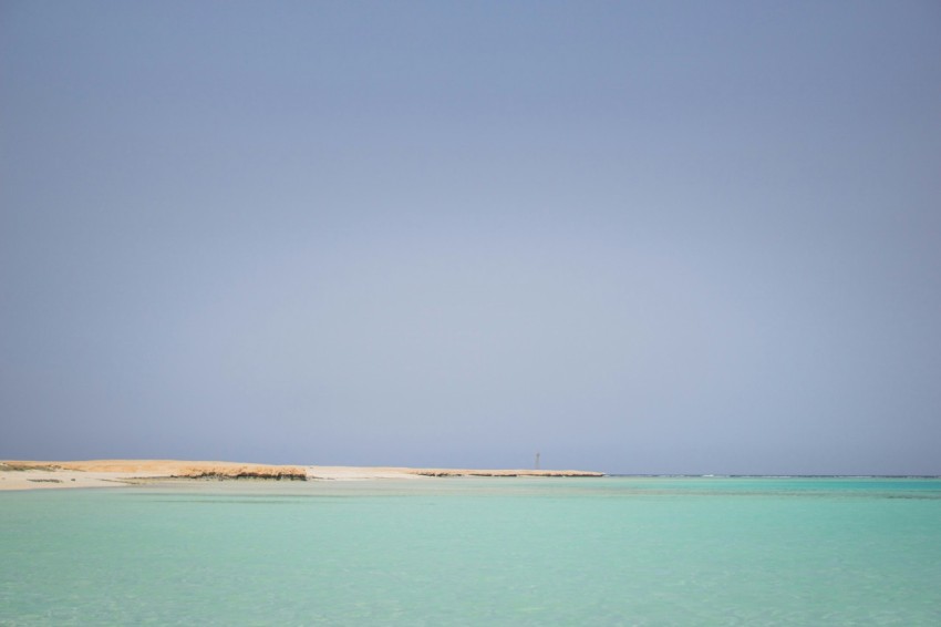 body of water under blue sky during daytime