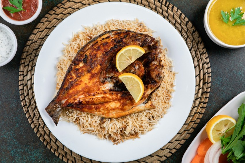 a plate of rice and fried fish