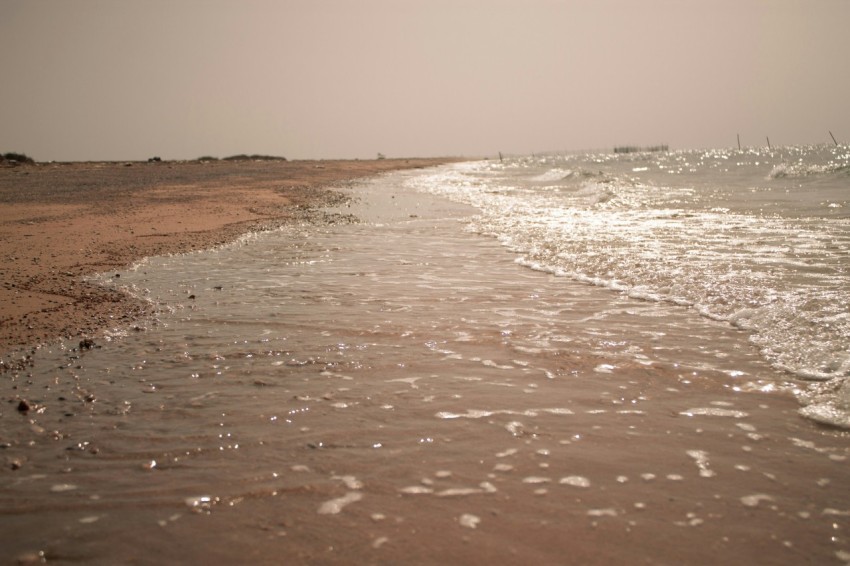 a beach with waves crashing on it