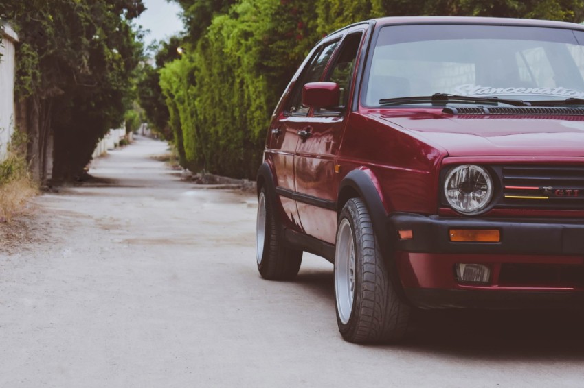 a red car parked on the side of a road