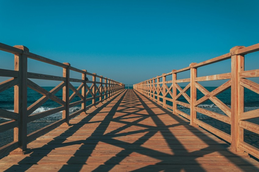 a long wooden pier stretching into the ocean