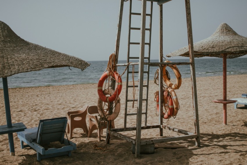 a beach with umbrellas and chairs