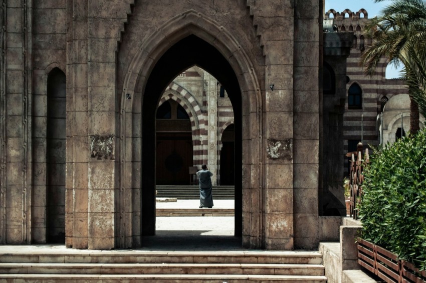 a person standing in a doorway of a building