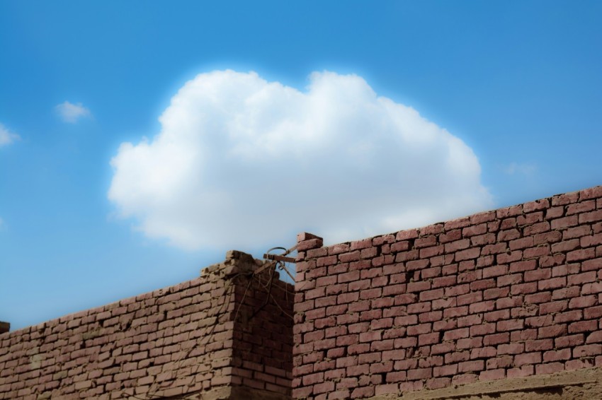 brown brick wall under blue sky during daytime