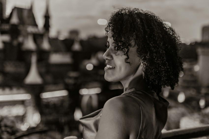 a black and white photo of a woman smiling