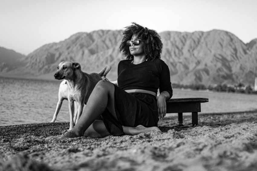 a woman sitting on a bench with a dog