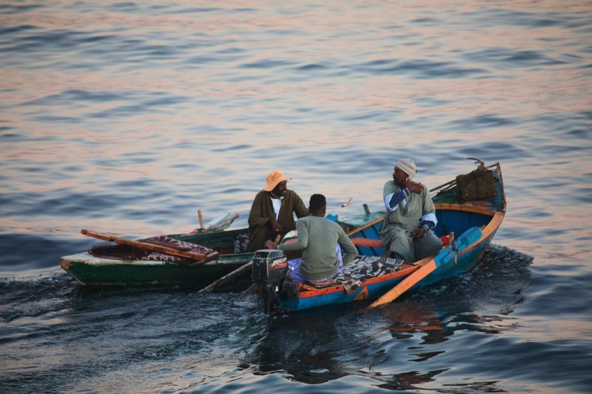 a group of people riding on the back of a boat