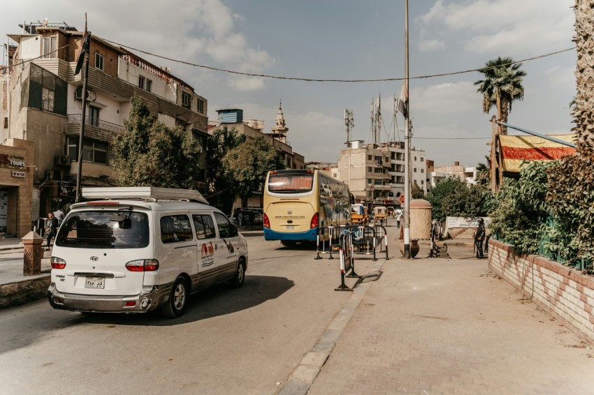 a street with cars bicycles and a bus