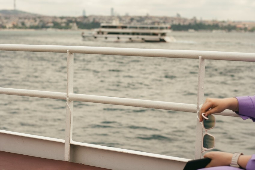 a person on a boat looking out over the water