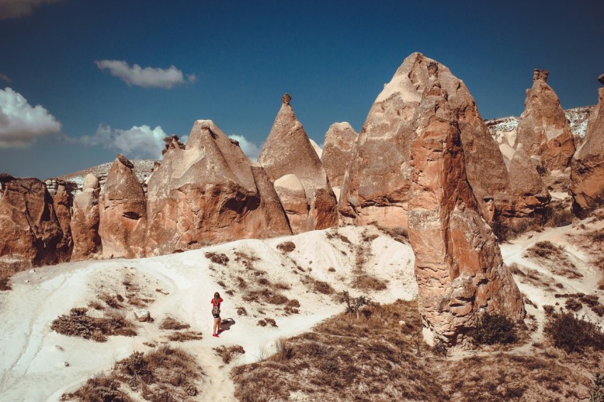 woman standing in front of huge boulders