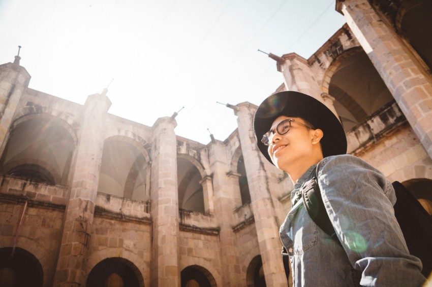 man smiling while looking at the building nmi2TJCW