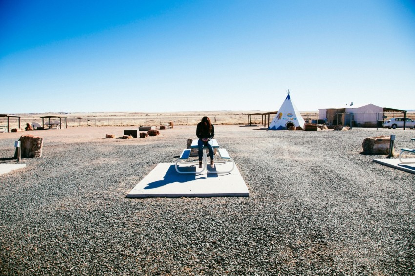 person sitting on the picnic table during daytime