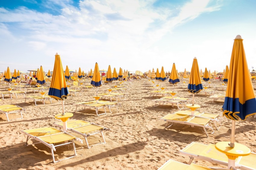 seashore with lounger and patio umbrella