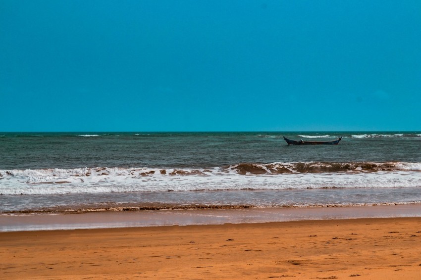 a boat is out in the ocean on a sunny day