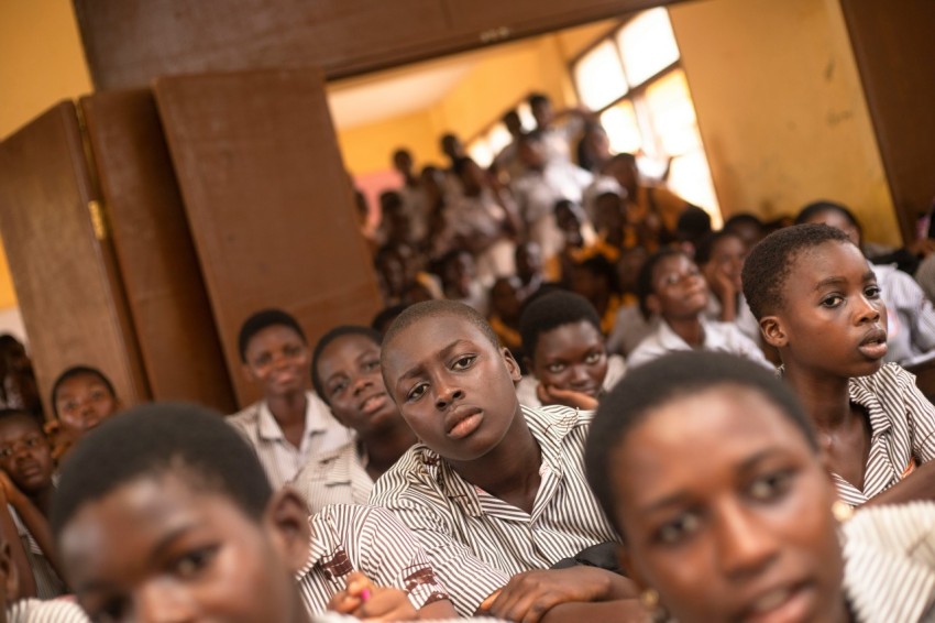 a group of young people sitting next to each other