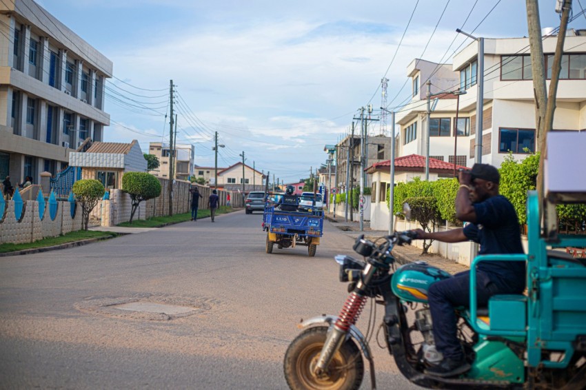 a man riding a motorcycle down a street