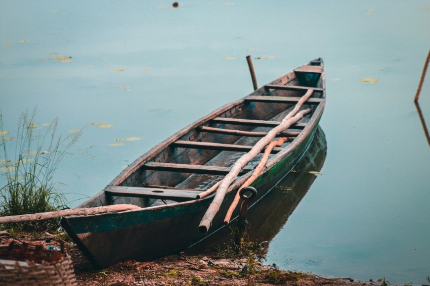 a small boat sitting on top of a body of water