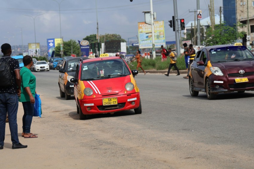 a group of people standing on the side of a road