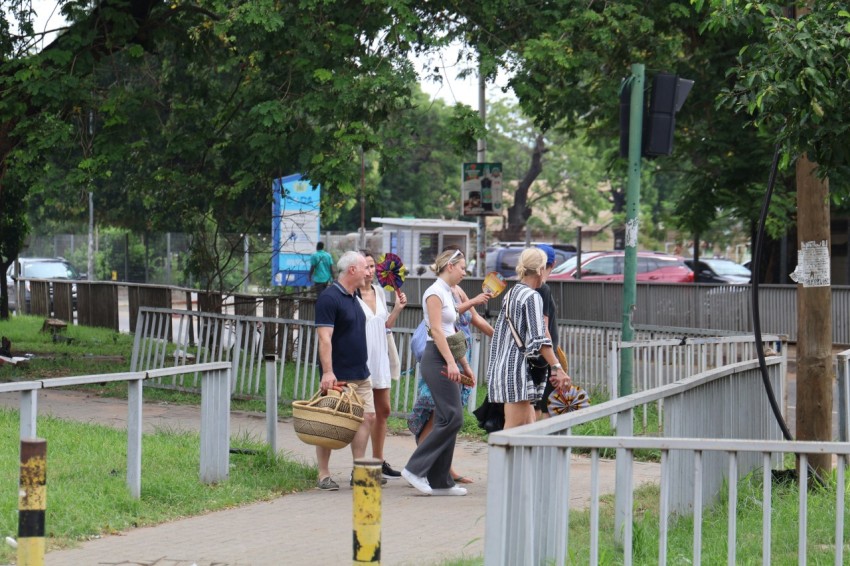 a group of people walking down a sidewalk