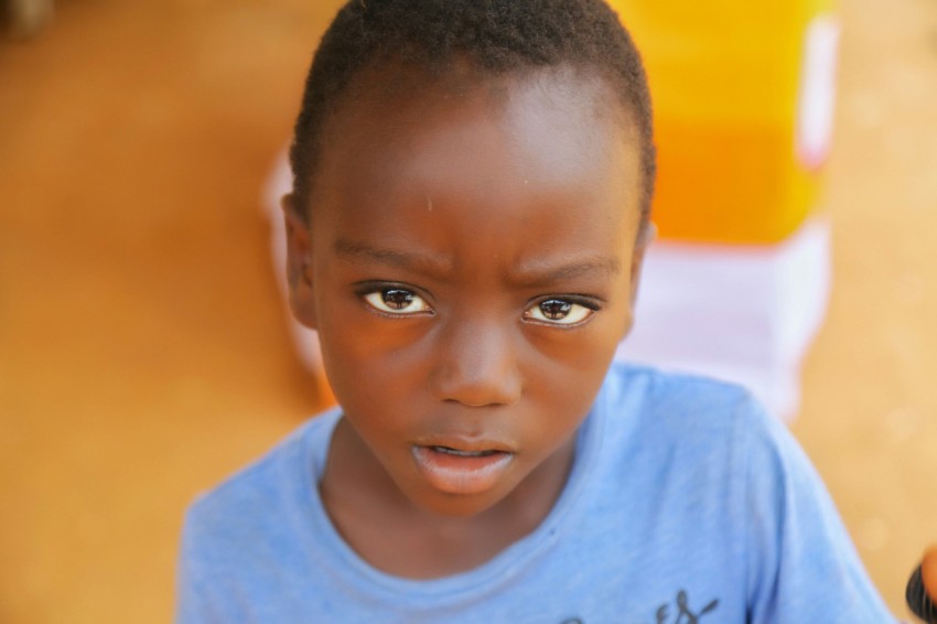 a young boy with a toothbrush in his hand