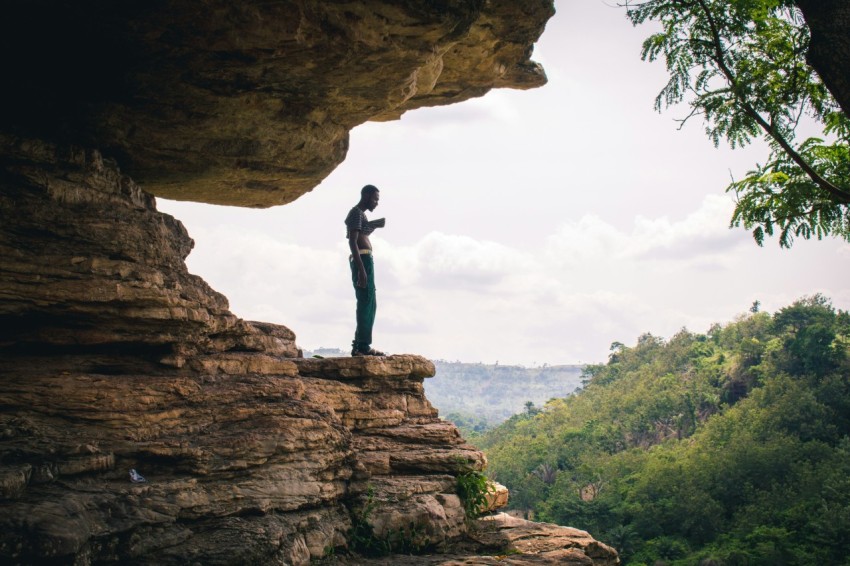 man standing on boulder