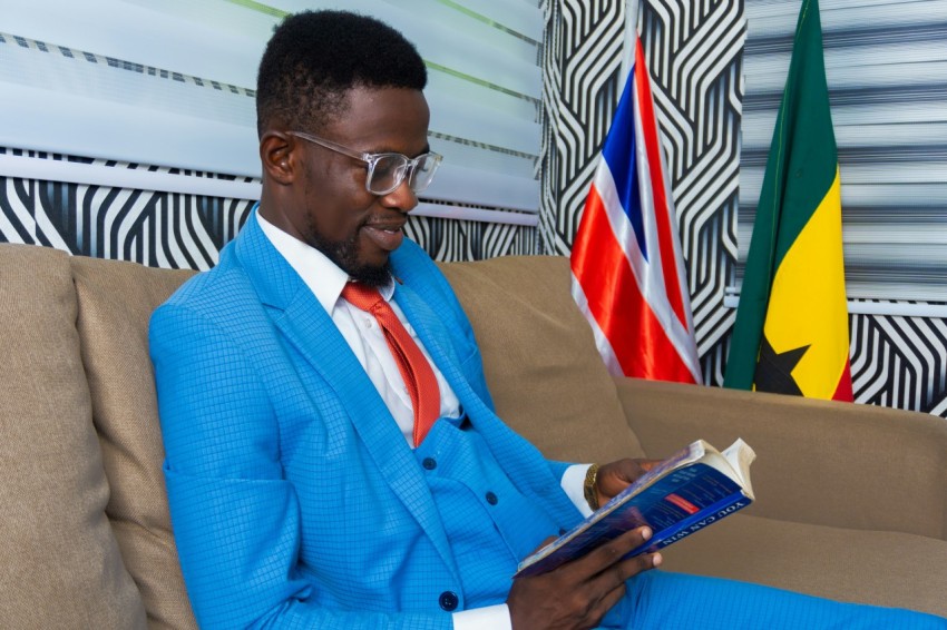 man in blue suit jacket holding smartphone