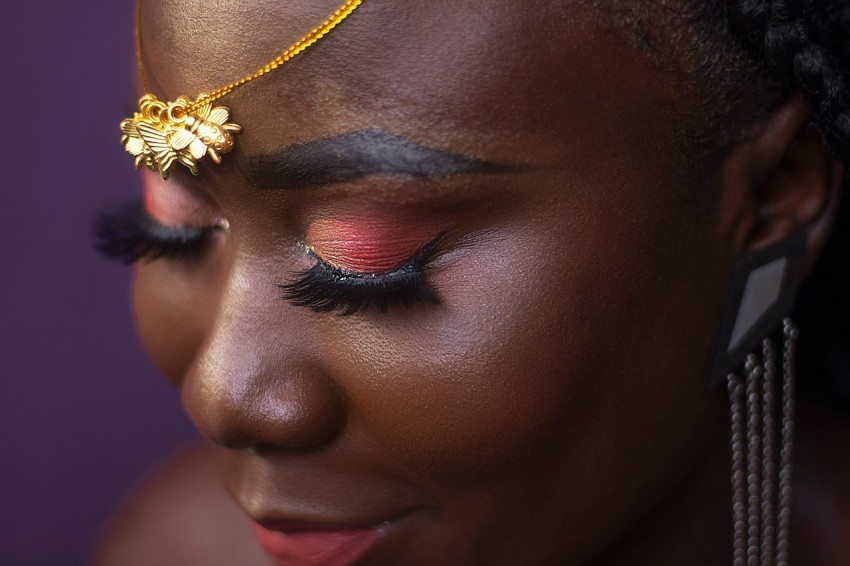 woman with gold flower on her face