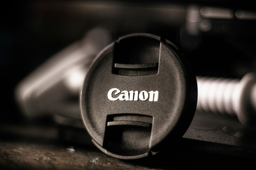 a camera lens cap sitting on top of a wooden table