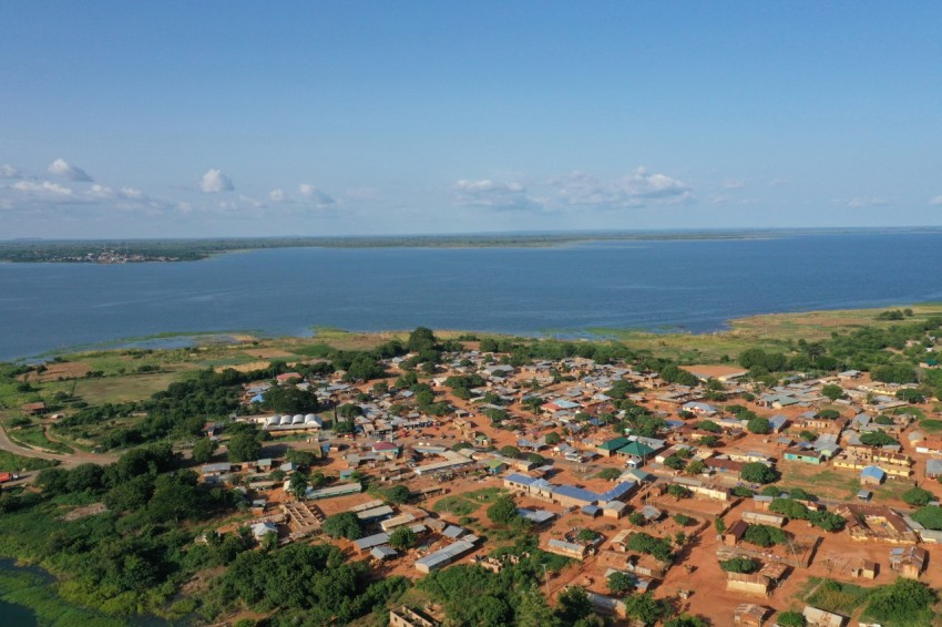 an aerial view of a village near a body of water